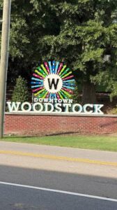 Downtown woodstock sign, where woodstock junk removal services are offered.